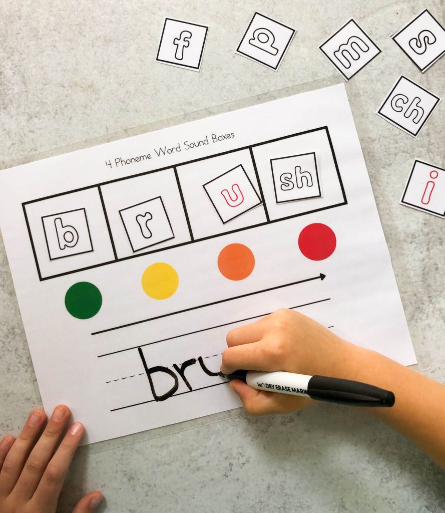 A child writing the word "brush" using Elkonin Boxes.