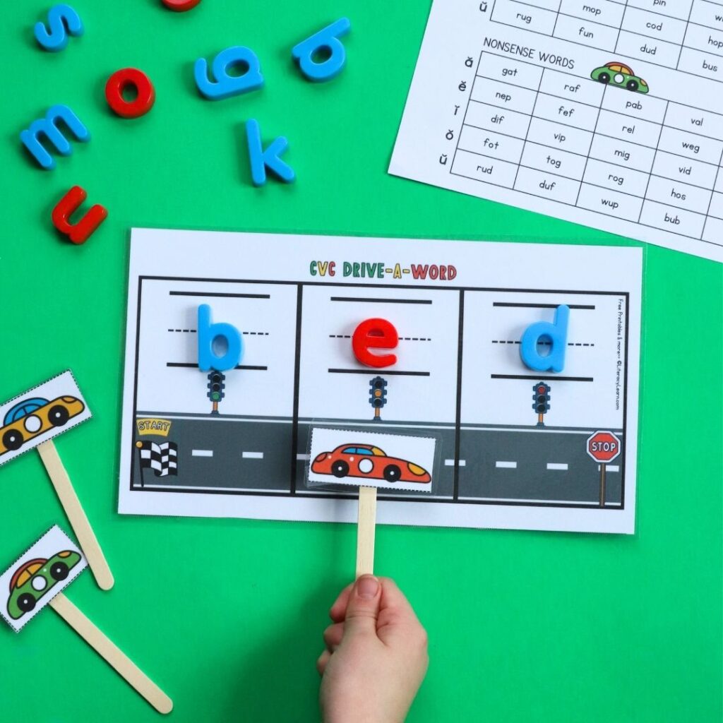 A child's hands "Driving" a car down a printed cvc words worksheet.