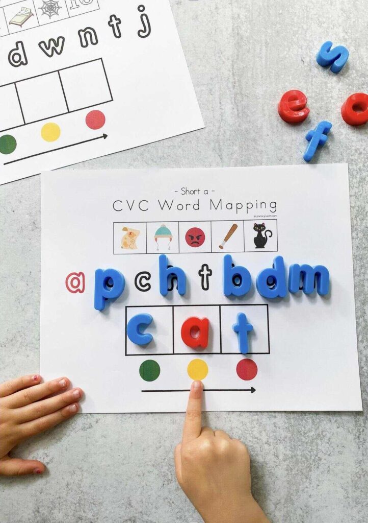A child using magnet letters on a printed cvc short a words picture mat.